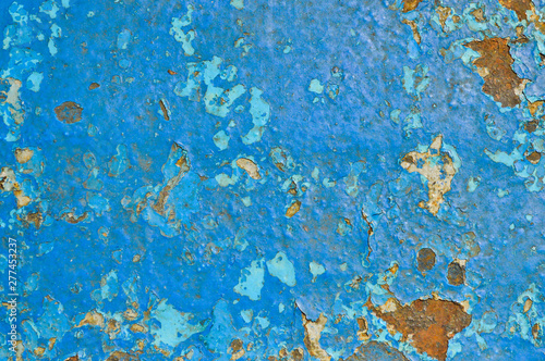 The texture of the iron metal painted blue paint old battered scratched cracked ancient rusty metal sheet wall with corrosion. The background