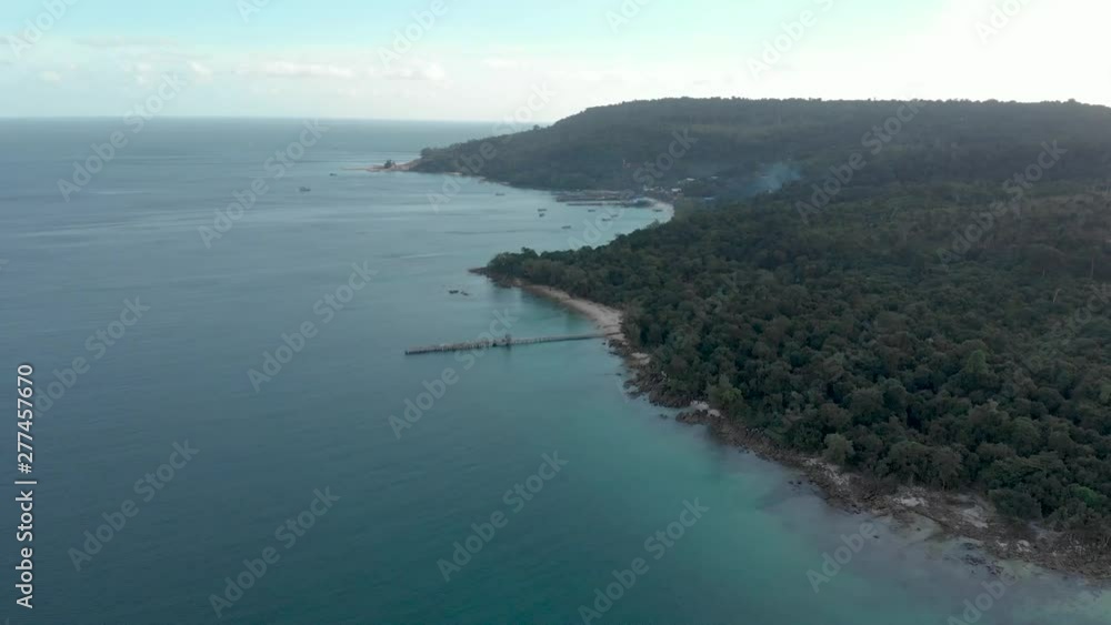 cinematic aerial shot of big waves crashing onto island coastline in cambodia asia at sunset with deep glow from sun over the ocean water cinematic aerial shot of big waves crashing onto island coastline in cambodia asia at sunset with deep glow from sun over the ocean water