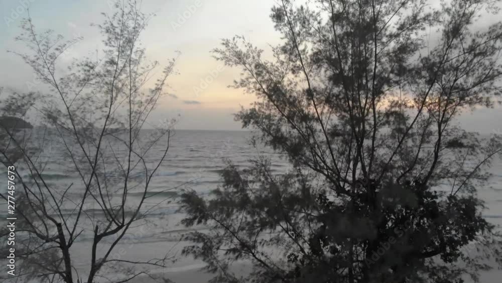 cinematic aerial shot of big waves crashing onto island coastline in cambodia asia at sunset with deep glow from sun over the ocean water cinematic aerial shot of big waves crashing onto island coastline in cambodia asia at sunset with deep glow from sun over the ocean water