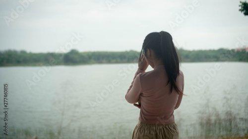 Sad young girl sitting alone outdoors. Teenage girl thinking thoughtfully. Hope. Sadness. Loneliness