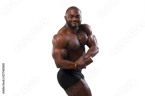 Athlete bodybuilder with beautiful torso, isolated on white background. The naked torso of African American man posing at studio.