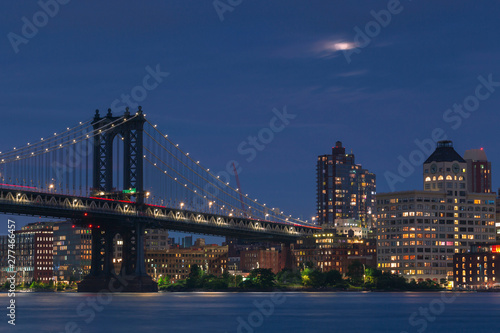 Manhattan Bridge and  Dumbo from East River with full moon at night  with long exposure photo