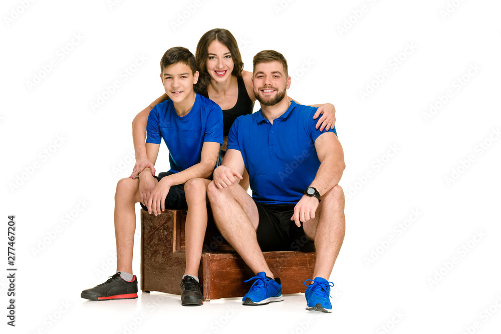 Fit athletic happy family in sportswear isolated on white background Fit athletic happy family in sportswear isolated on white background