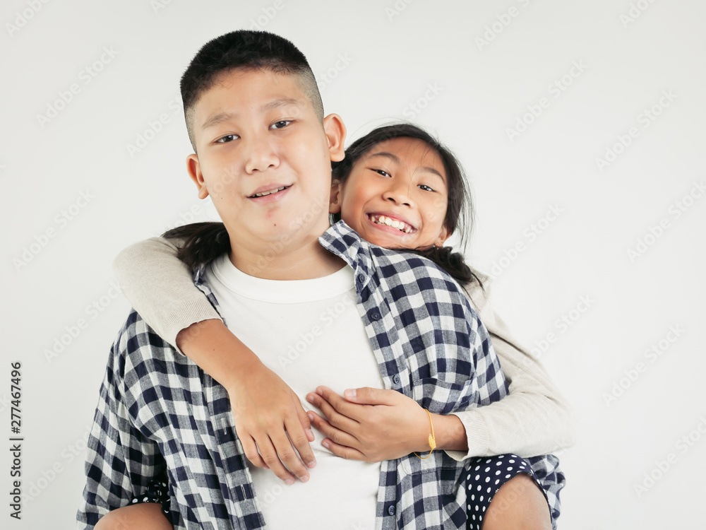 Happy Asian pretty girl enjoying riding on her brother piggyback, lifestyle concept. Happy Asian pretty girl enjoying riding on her brother piggyback, lifestyle concept.