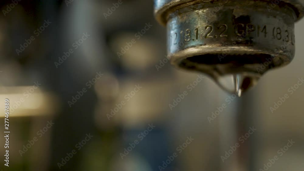Macro shot of a dripping water faucet - truck right Macro shot of a dripping water faucet - truck right