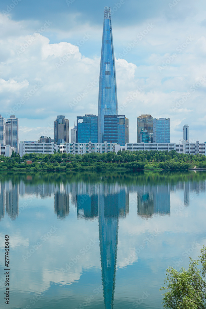 Lotte World Tower and cityscape with clear blue sky.
