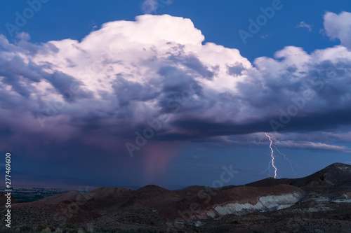 Thunderstorm with lightning stike after sunset in the desert