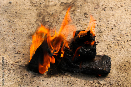 burnt mobile phones on textural concrete background. Concept: Danger of using low-quality cell phones.