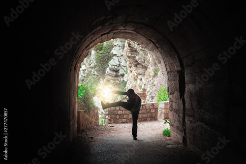 Man practicing karate moves in a tunnel