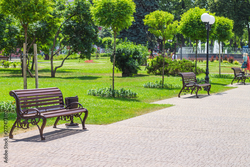 Landscape design of the city park with benches and a fountain. Decorating of city parks