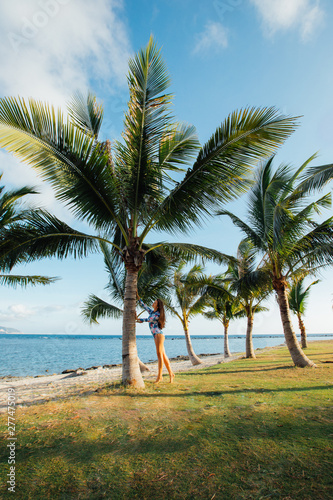 beautiful girl near palm trees in front of the sea in Sanya © Владимир Козлов