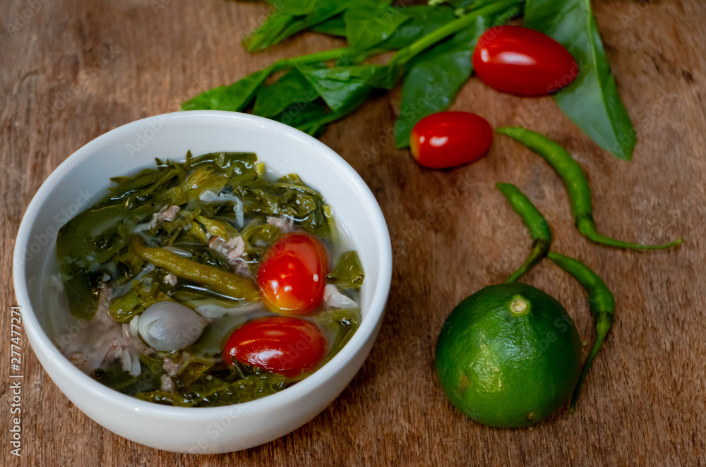 Hot, sour and spicy Basella alba or Ceylon Spinach leaf with fermented sausage soup. Northern Thai food with high vitamin vegetable.