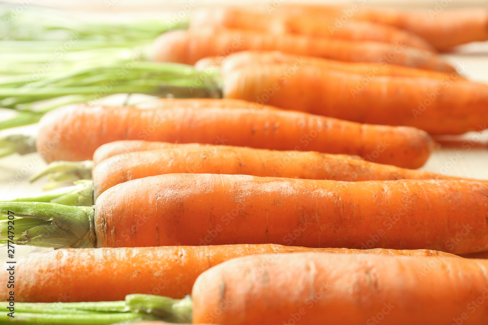 Tasty fresh carrot on table, closeup Tasty fresh carrot on table, closeup