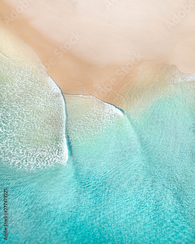 Aerial of a beach with beautiful waves, white sand and ocean textures © FRPhotos