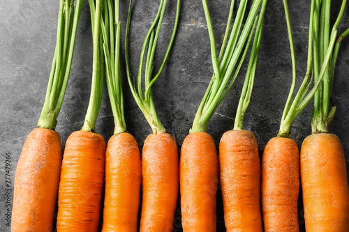 Tasty fresh carrot on dark background