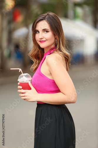 Beautiful young woman drink...