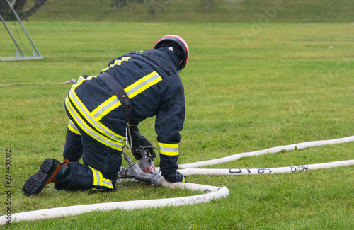 a fire brigade worker blocks the wick of water