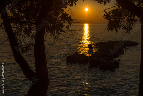 Beautiful sunset with trees and rocks in Dingac Borak, Dalmatia, Croatia, Peljesac peninsula photo