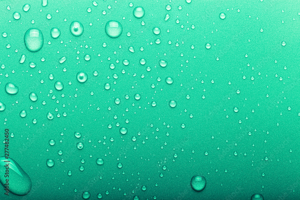 Drops of water on a color background. Selective focus. Green. Toned