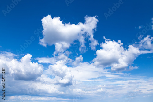 Cloudscape. Blue sky with large white clouds. Beautiful big clouds slowly float against the blue sky.
