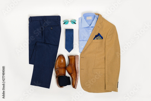 Men's casual outfits for man clothing set wit suit, sunglasses, trousers, socks, shirt, and shoes isolated on white background, Top view. pack shot