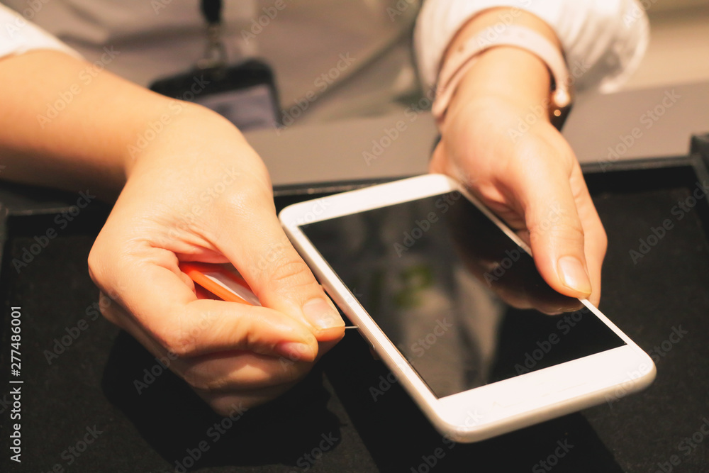Employees are putting nano-SIM cards in the store for customers to buy women hands. Employees are putting nano-SIM cards in the store for customers to buy women hands.