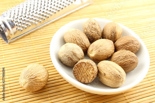 nutmeg seeds in a small white bowl