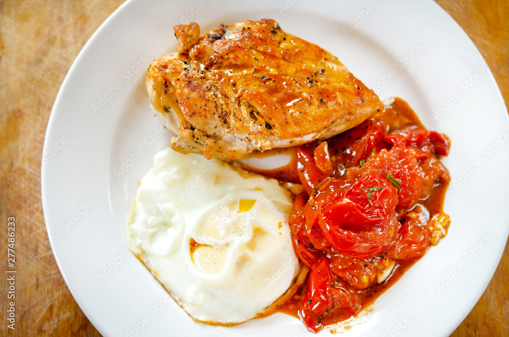 Close up of Fried chicken fillet with garnish of tomato Close up of Fried chicken fillet with garnish of tomato
