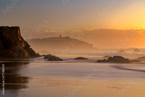 Hazy morning lighthouse beach