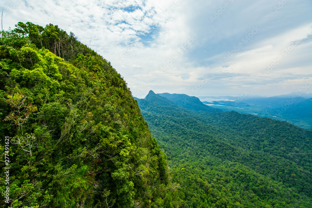 Aerial view of Langkawi island forest and mountains  with blue sky background