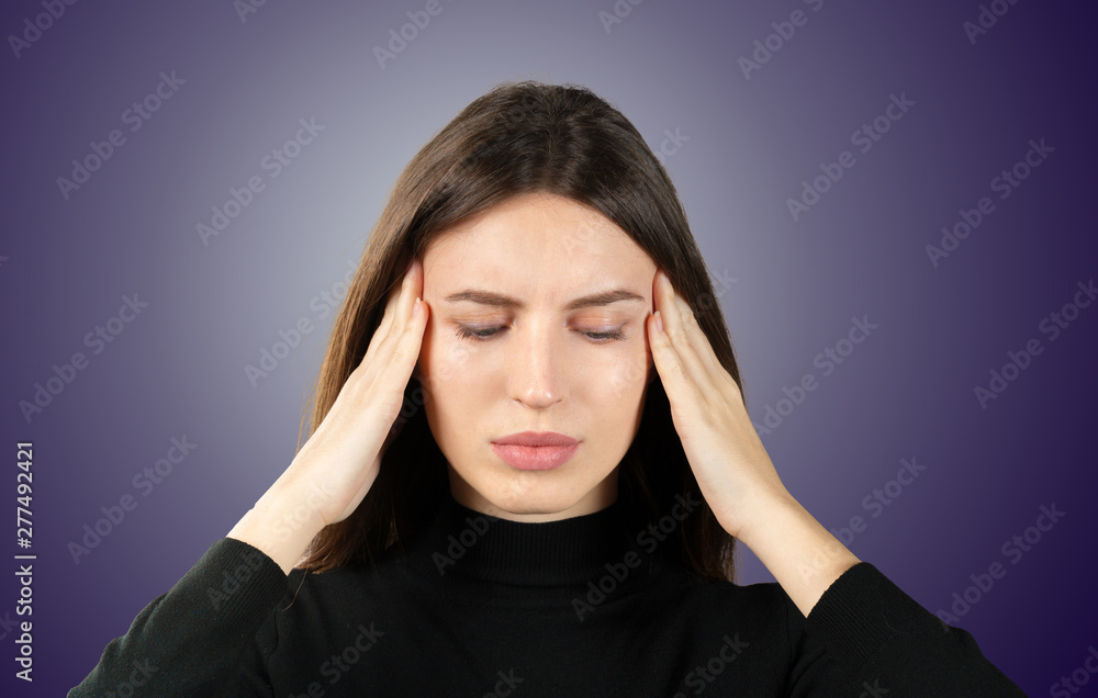 A woman with a pain in her head holds on to her head a migraine A woman with a pain in her head holds on to her head a migraine