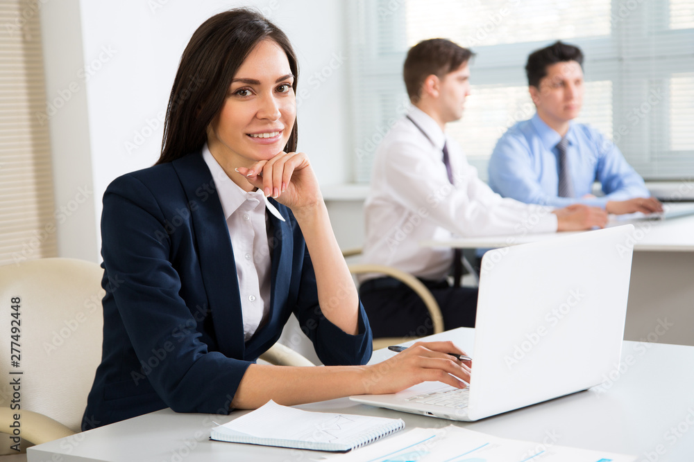 Young business woman smiling looking at camera Young business woman smiling looking at camera