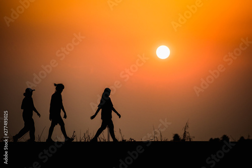 woman walking on sunset background
