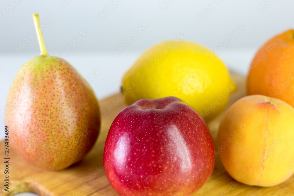 red apple, pear, lemon, orange, peach on white background, copy space red apple, pear, lemon, orange, peach on white background, copy space