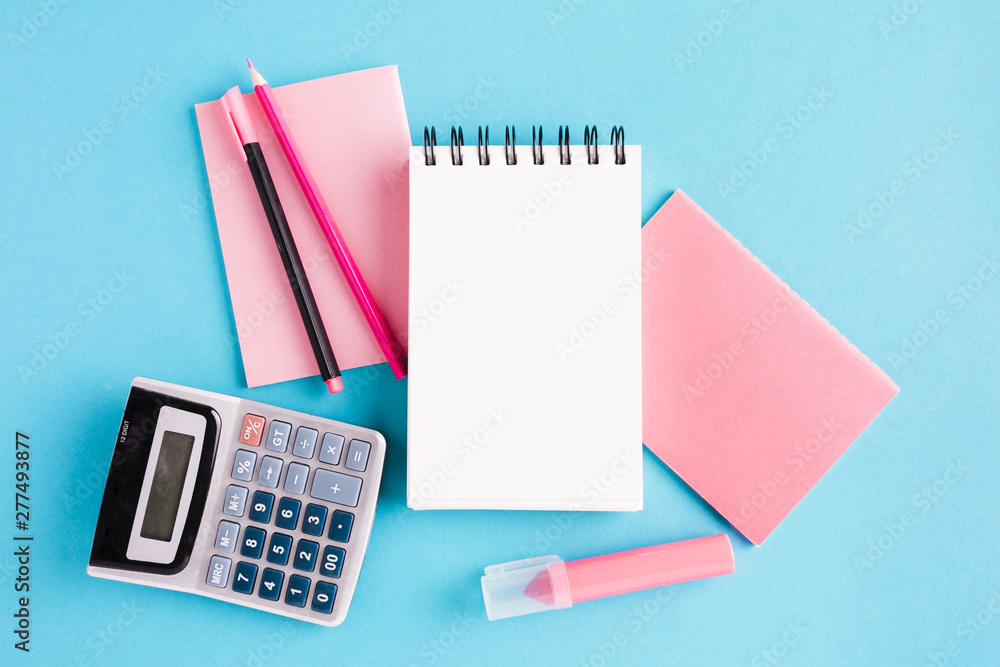 Scratchpad and office tools on blue surface Scratchpad and office tools on blue surface