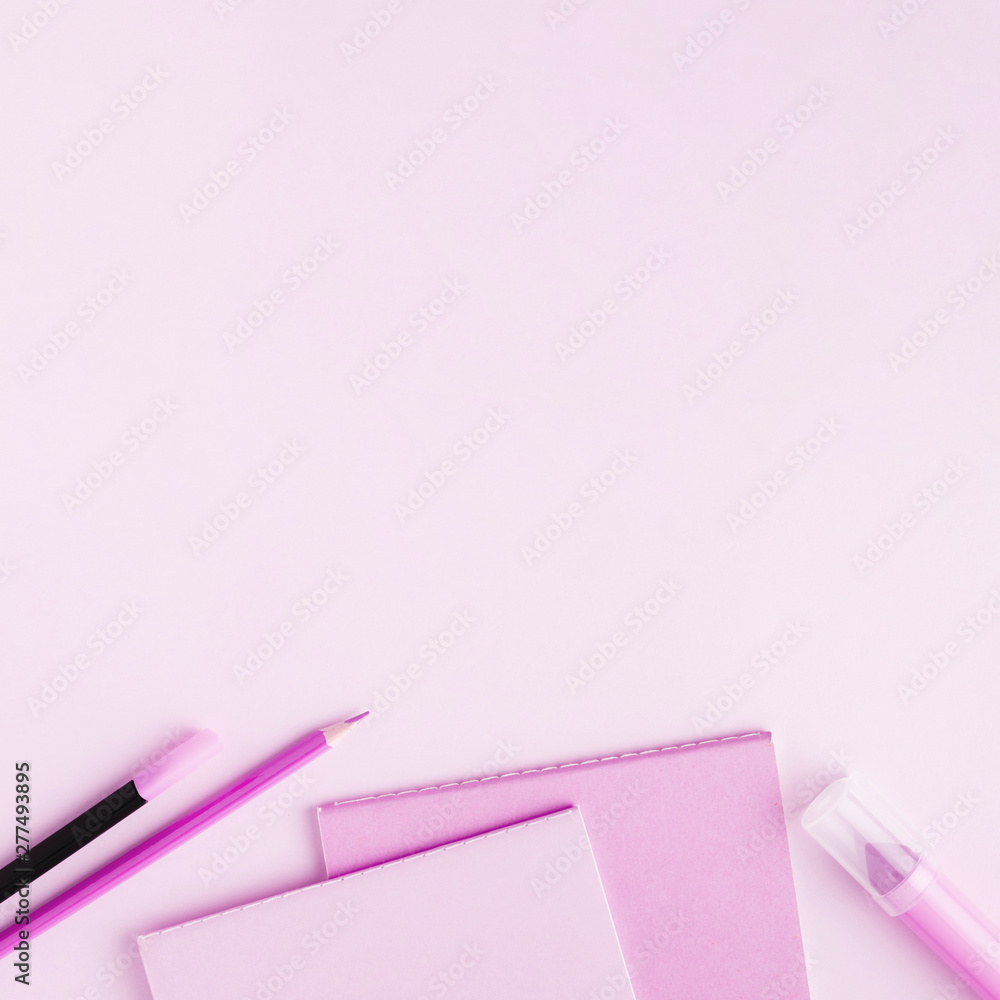 Pink stationery set on colored surface Pink stationery set on colored surface