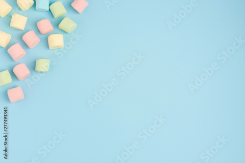 Marshmallow on blue colour background. Cozy sweet background