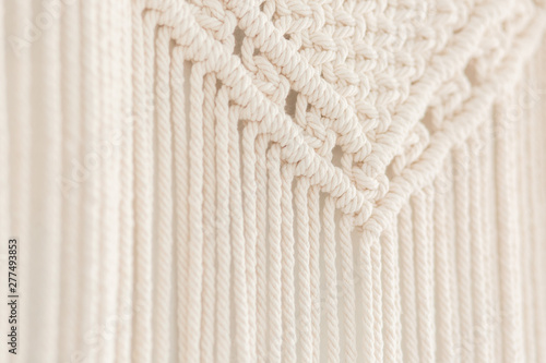 Close up of handmade cotton macrame panel. Texture. Background.