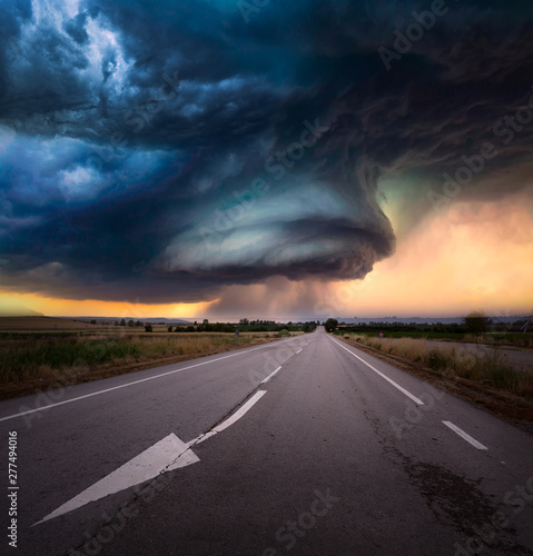 super cell storm in Kansas eeuu with a road and sunset light 