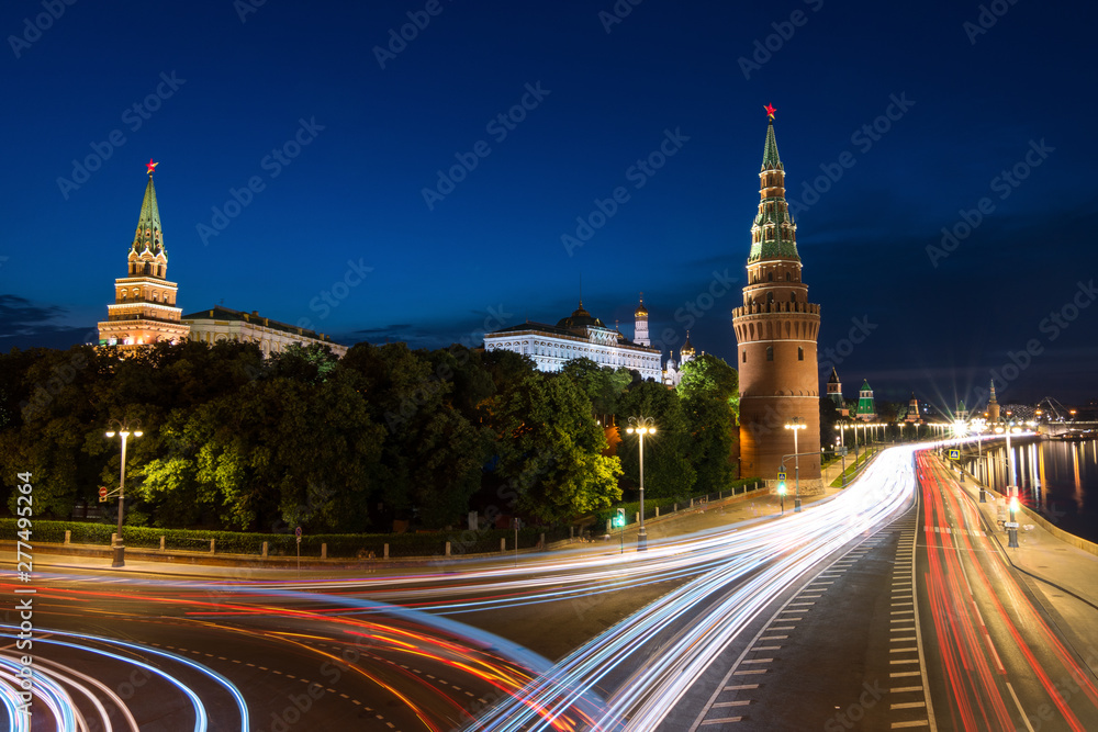 heavy traffic early in the morning near to kremlin in Moscow with cloudy sky, captured as light trails during long exposure during blue hour