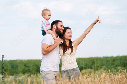Parents and son family portrait. Daddy, mom and child having fun outdoors