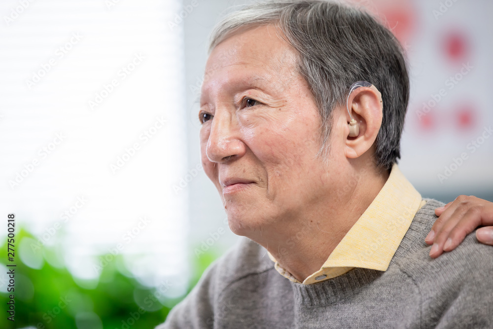 Doctor help patient wear audiphone Doctor help patient wear audiphone