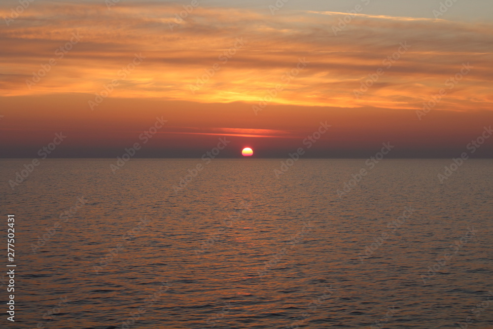 evocative image of sunrise over the sea with the sun rising over the horizon evocative image of sunrise over the sea with the sun rising over the horizon