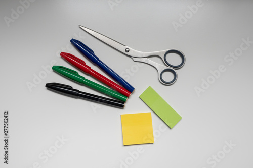 Image photograph of a four-color sign pen and stainless steel scissors for stationery