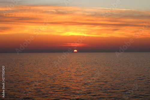 evocative image of sunrise over the sea with the sun rising over the horizon © massimo
