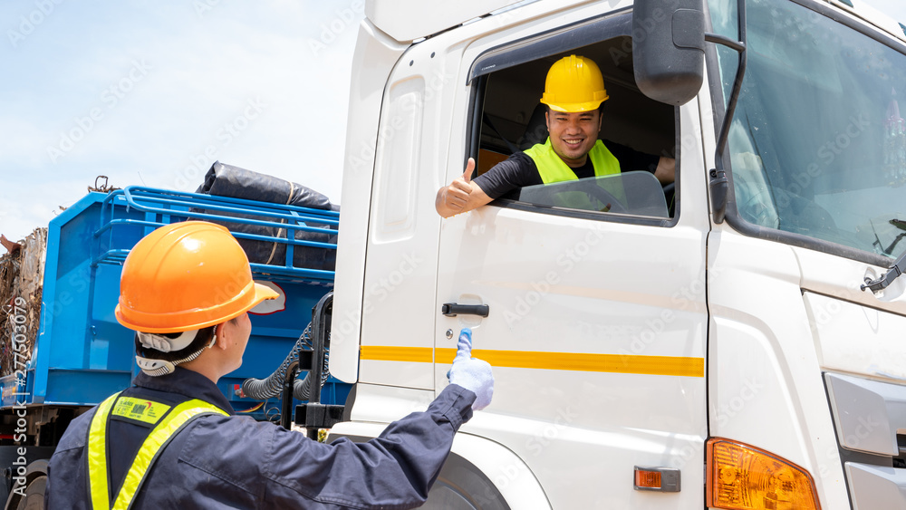Foreman with safety hats and safety vest is carrying a car inspection  document in the parking with truck drivers,Concept of planning work day.  Stock Photo | Adobe Stock