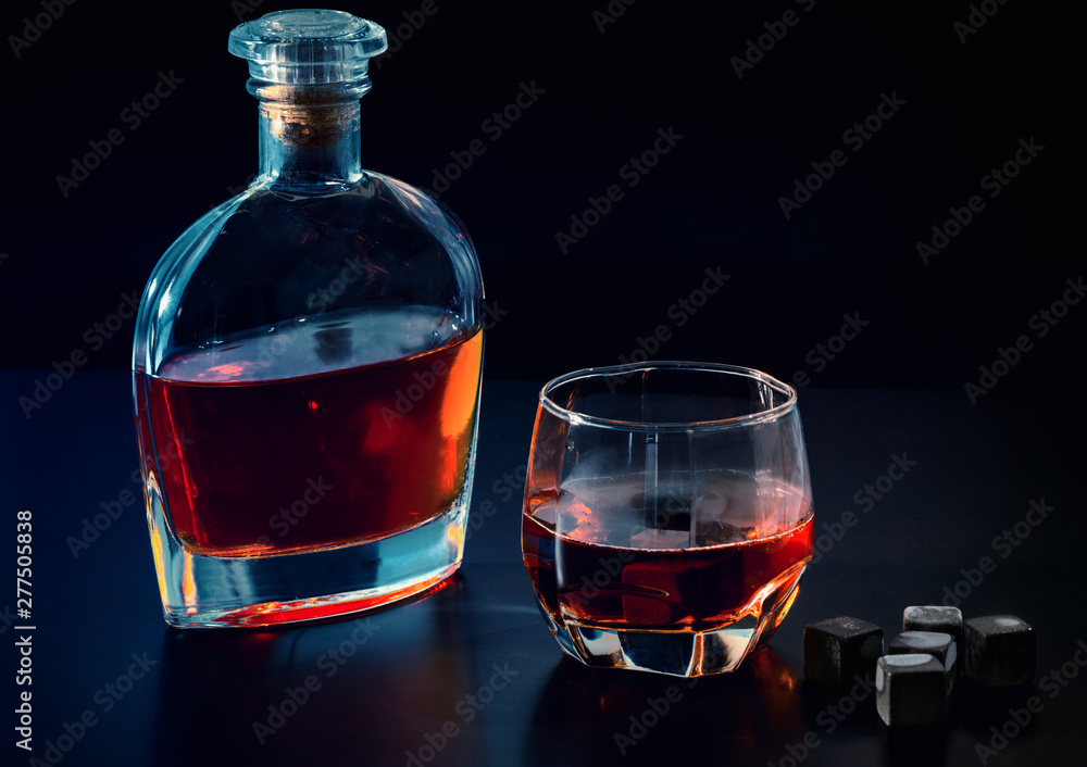 Bottle of cognac or whiskey with full glass Bottle of cognac or whiskey with full glass