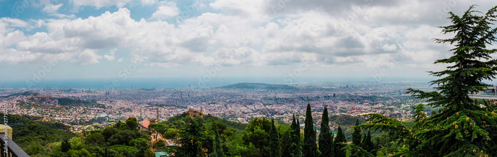 Panorama: view of Barcelona and the sea from Mount Tibidabo on a cloudy day