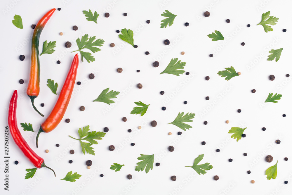 Fototapeta premium Pattern of vegetables. Food background. Composition of chili peppers, parsley and spices on white background. Top view.