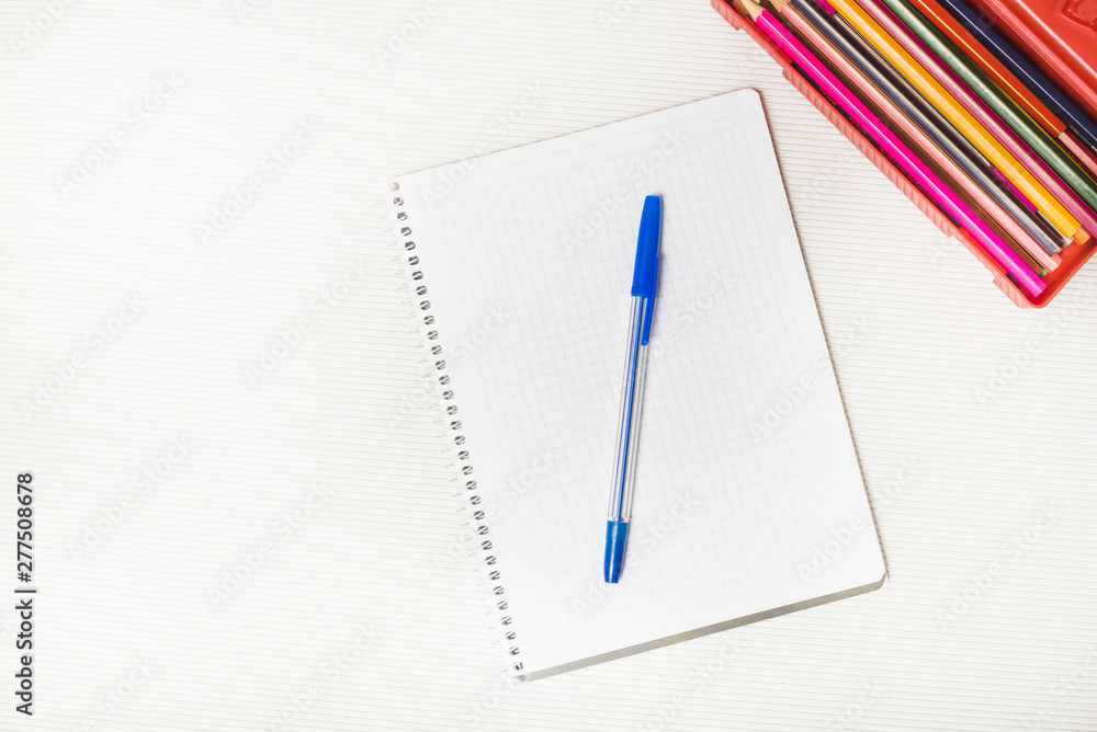 Pencils near notepad and pen Pencils near notepad and pen
